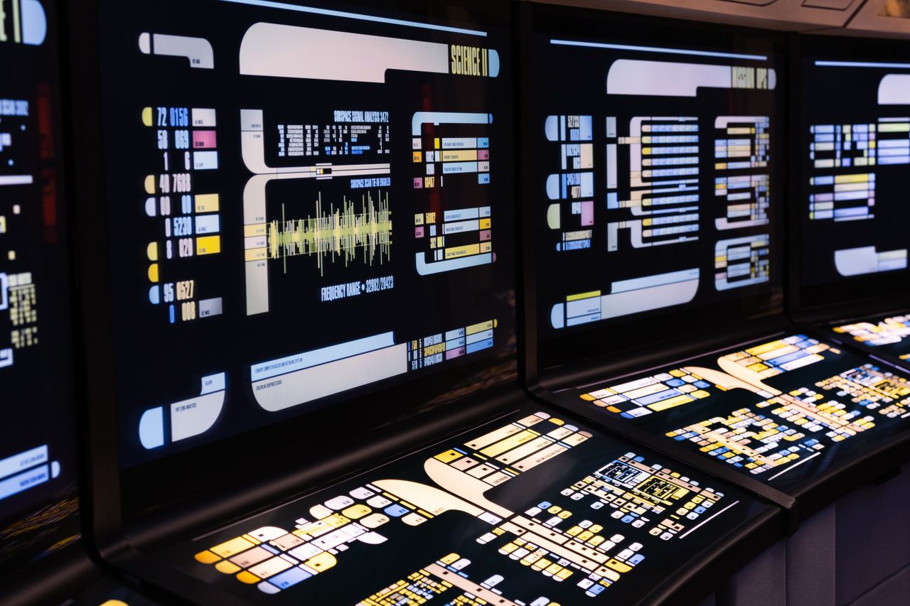 cta-bg High-tech command center with advanced digital displays and control panels